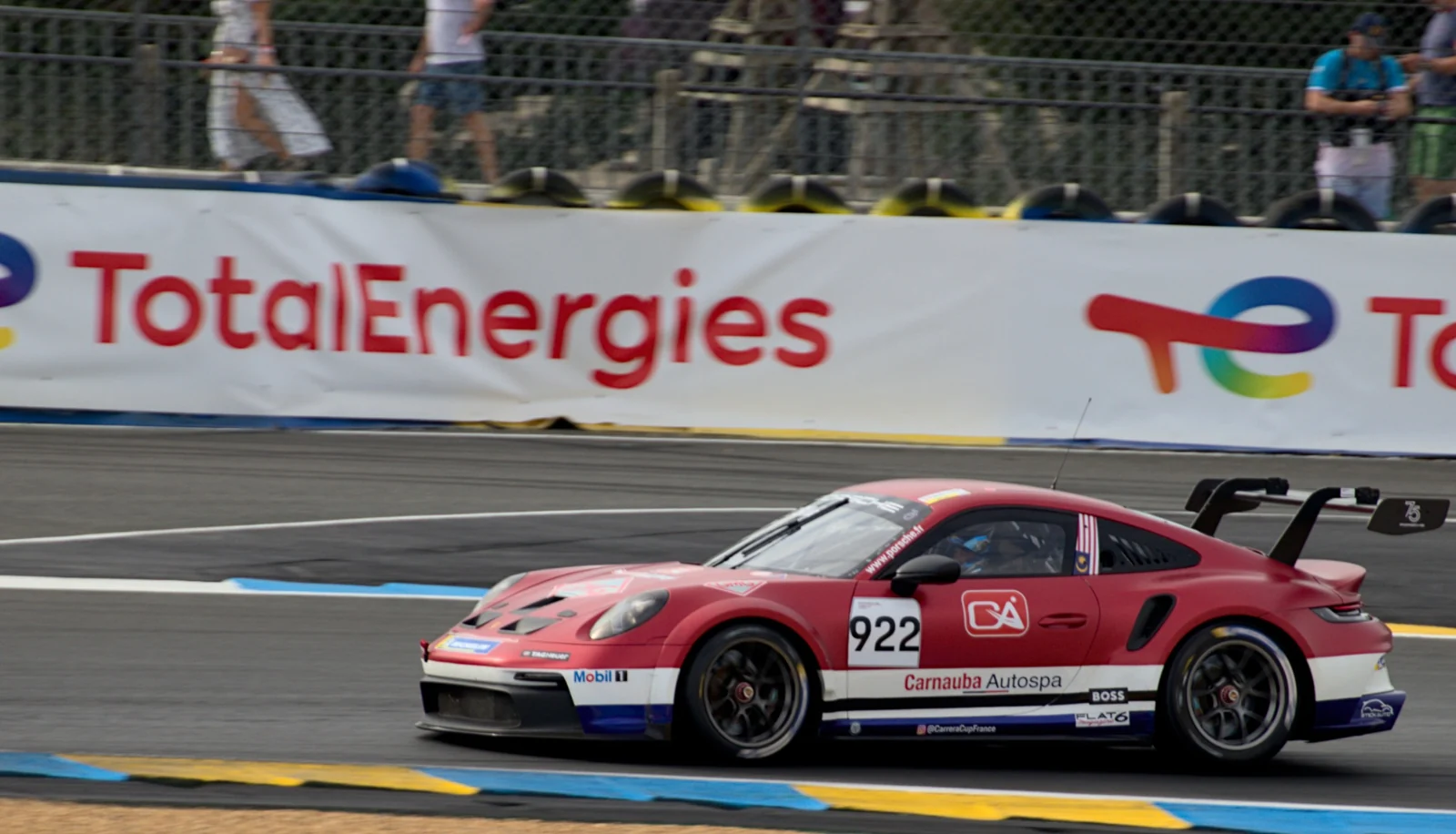 A red and white race car negotiating a corner.