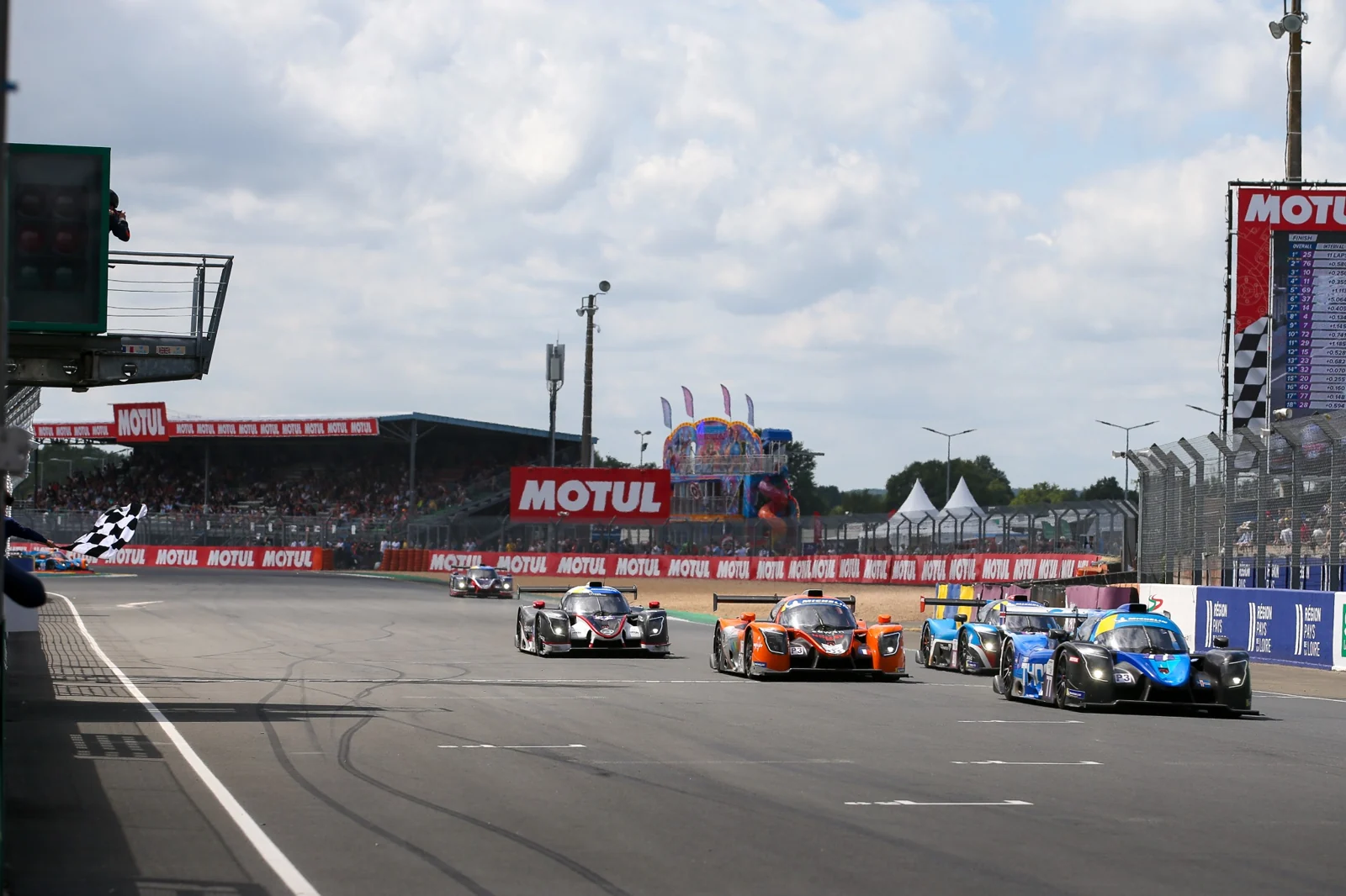 Prototype race cars approaching the finish line.
